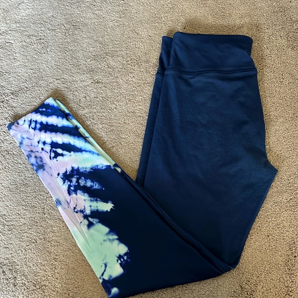 Navy exercise leggings with cyan and lavender coloration on lower pant legs